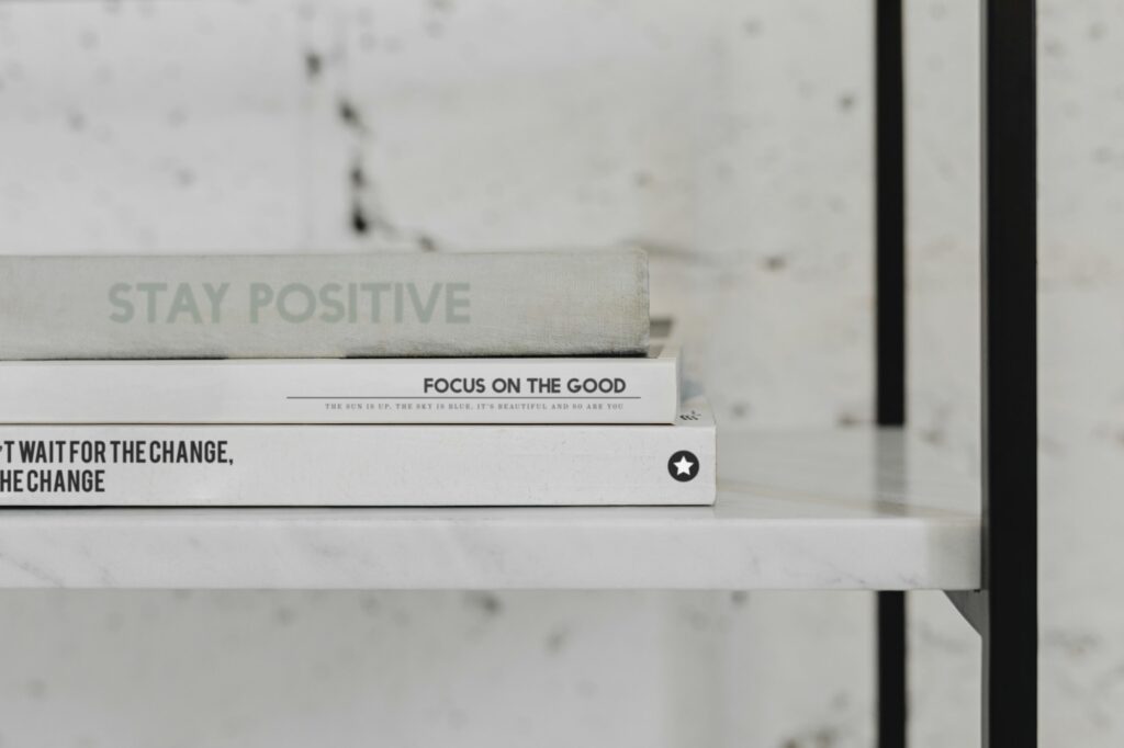 Stack of psychology books on a white marble shelf
